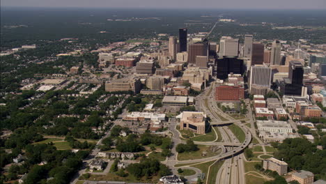 aerial view of a bustling city with a prominent skyline and intersecting highways