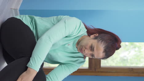 Vertical-video-of-Exhausted-thoughtful-woman-leaning-her-head-against-the-wall.