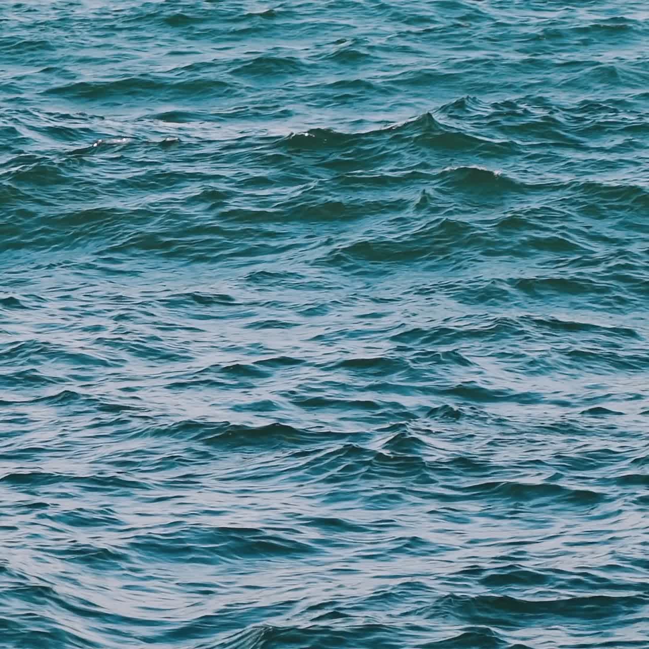 Sea landscape at storm. Blue sea waves at daytime. Restless sea background. Water texture. Slow motion.