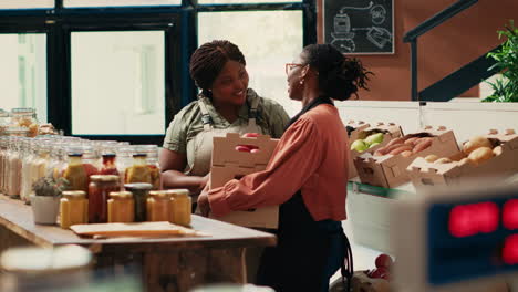 market employee receiving products from farmers daughter