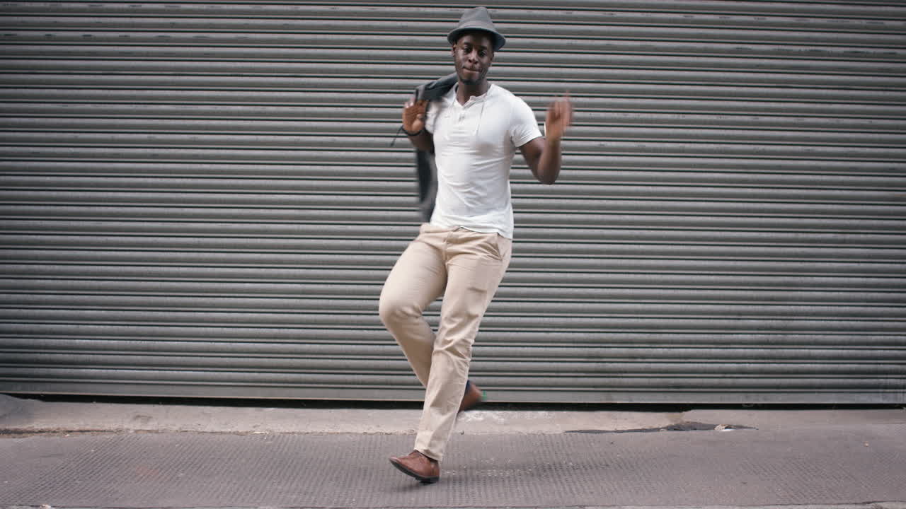 uomo afroamericano che balla per strada che si diverte a festeggiare con una danza divertente 4k