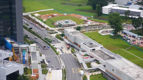 urban aerial view of city intersection with construction and shopping mall