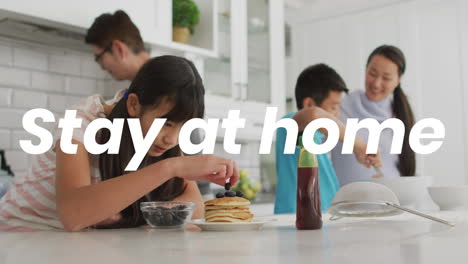 animation of stay at home text over happy asian family at home