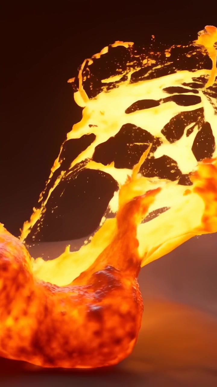 Video verticale: Lava che si gonfia spingendo verso l'alto, sollevando la crosta carbonizzata ed estrudendo filamenti incandescenti in studio.