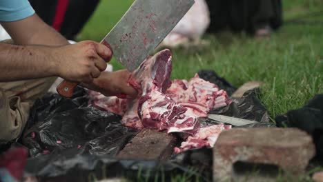 middle eastern man chops and cuts sheep and goat meat to eat in celebration of muslim, religious holiday ramada, eid al-adha or eid al-fitr in cinematic slow motion