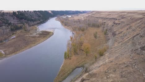 Aerial-flight-up-lower-Bow-River-Valley-with-dry-autumn-riverbanks