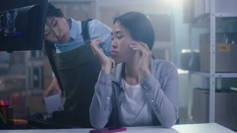 two asian women working in a warehouse