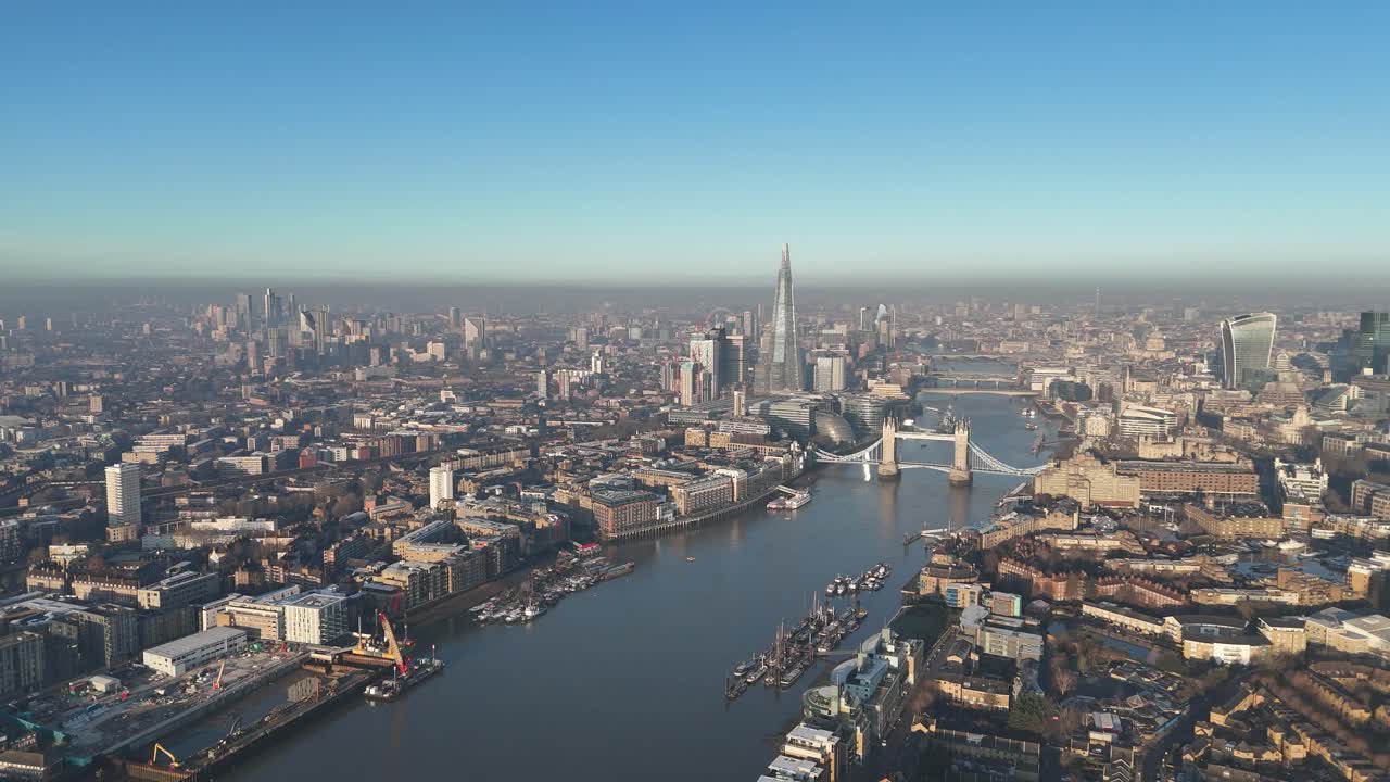 Epic aerial drone footage soaring from East to West London, revealing the stunning city skyline and the iconic Tower Bridge in breath-taking detail. Perfect for cinematic urban visuals.
