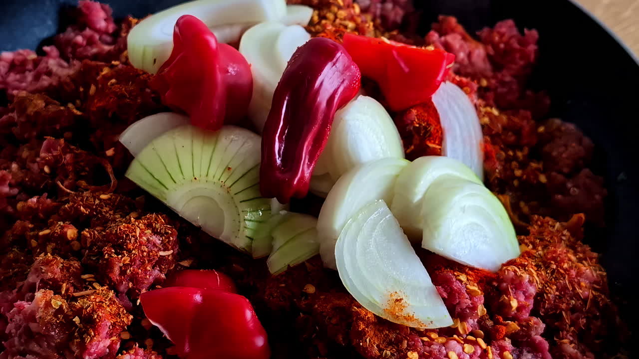 Uncooked Ground Beef With Chopped White Onions And Red Peppers. closeup shot