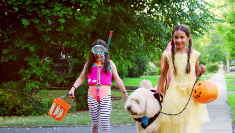 children and dog in halloween costumes for trick or treating
