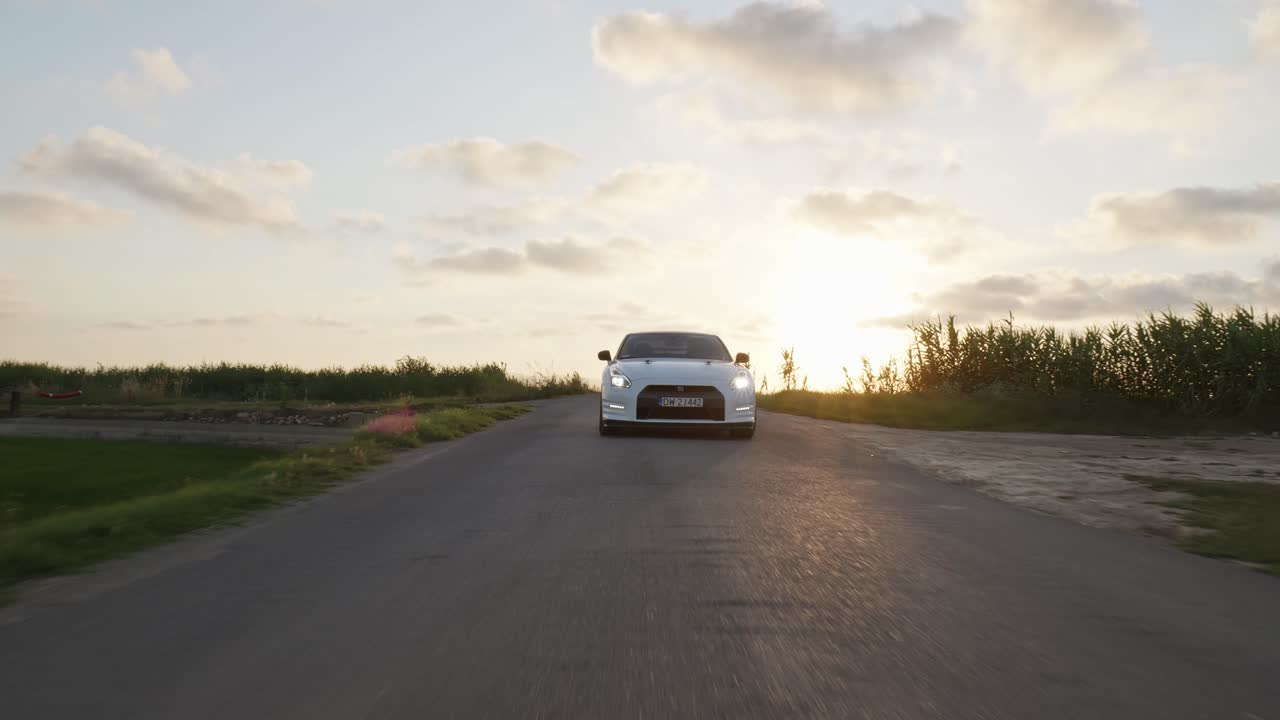 White Nissan GTR sports car drive countryside road