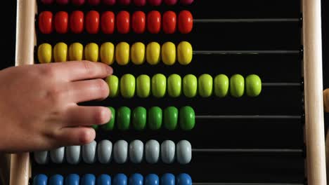 a child moves beads on an abacus