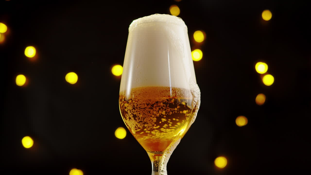 Glass of Frothy Beer with Festive Lights