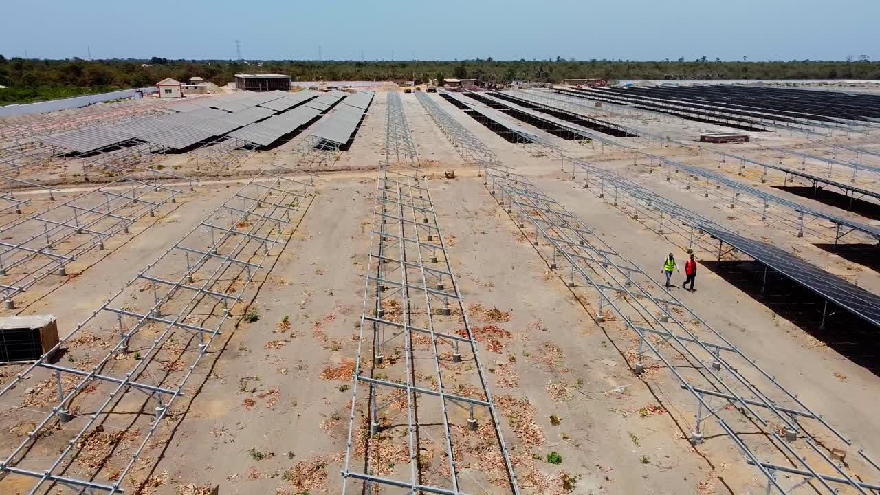Drone flyover dusty solar cells at a photovoltaic energy plant project in Africa