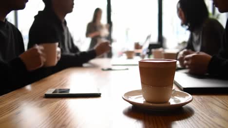 a cozy cafe scene: friends gathering over coffee during a relaxed meeting, fostering connection and collaboration amidst lively conversations and warm beverages