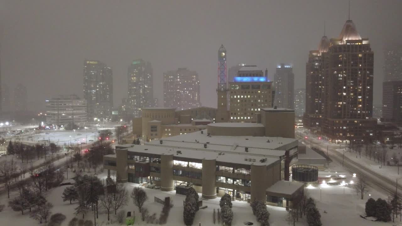 Aerial establishing shot of Mississauga with poor visibility due to heavy snowfall
