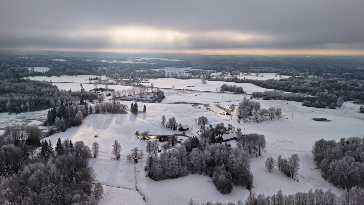 Overcast winter sky above a snow-covered village and frosty fields