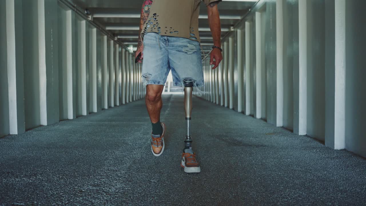 Man with Prosthetic Leg Walking in a Modern Tunnel