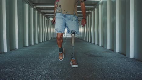 man with prosthetic leg walking in a modern tunnel
