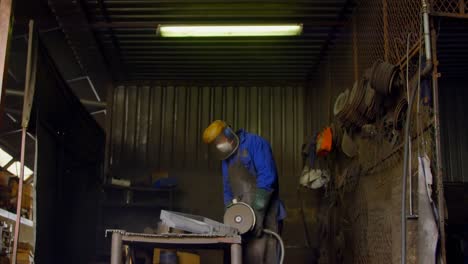 male worker using grinder machine in workshop 4k