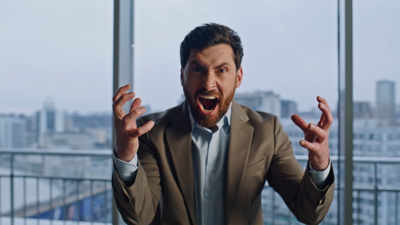 Portrait furious ceo shouting at office windows. Angry mad boss looking camera