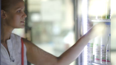 Woman-choosing-milk-at-the-shop