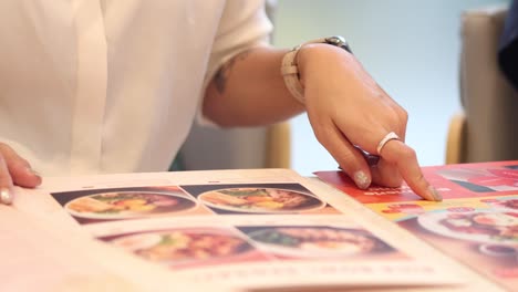 hands organizing colorful menu cards in sequence