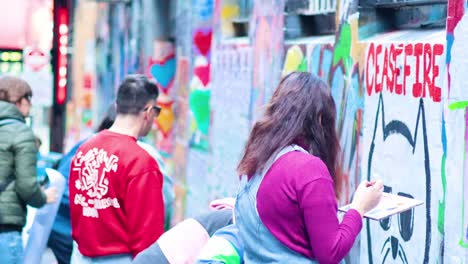 group creating vibrant graffiti in melbourne alley