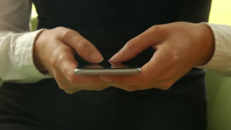 businesswoman using her phone in reception