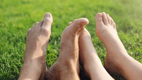 barefoot feet of young couple in love playing footsie