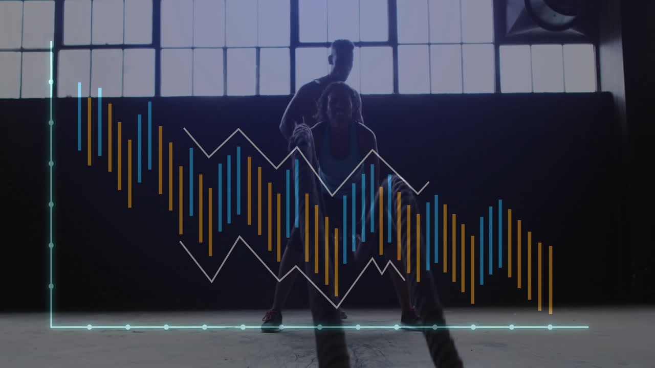 Female trainee performing battle ropes in lit gym studio, displaying animated bar and line charts