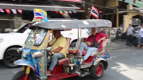 colorful tuk-tuks and pedestrians in busy city traffic