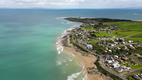 an aerial shot over a calming coastline of riverton, new zealand