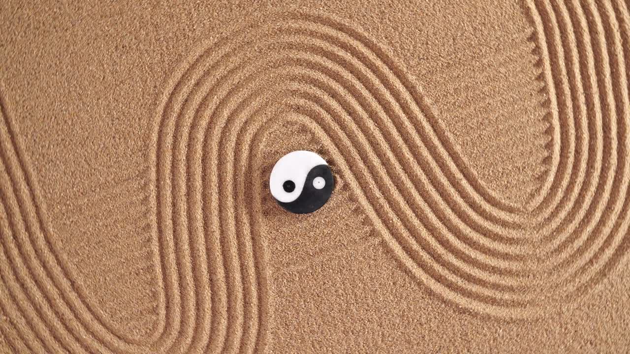 Japanese garden with yin yang stones laying in textured sand