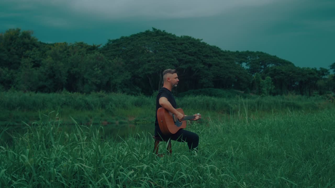 Man Playing Guitar in Nature