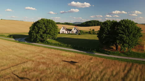 scenic farmhouse in a golden wheat field