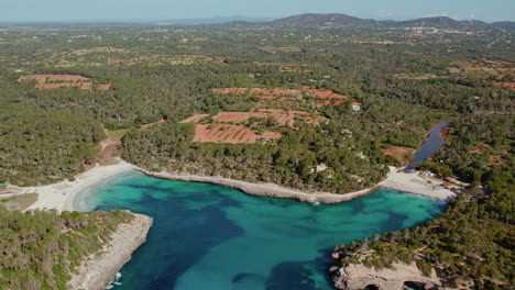 beach of s'amarador and cala mondrago surrounded by coastal lush greenery in mallorca, spain