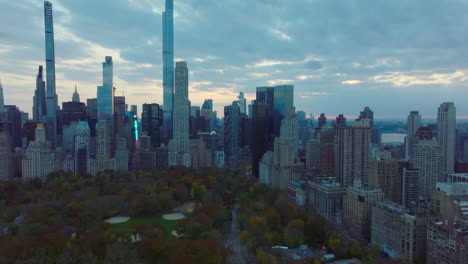 Diapositiva-Y-Toma-Panorámica-De-Los-Rascacielos-Del-Centro-Alrededor-Del-Parque-Central.-Follaje-De-Color-Otoñal-En-Los-árboles-En-El-Parque.-Manhattan,-Ciudad-De-Nueva-York,-Estados-Unidos