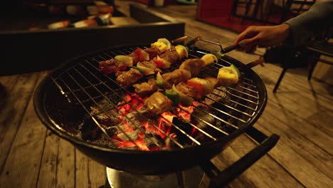 preparing skewers on a charcoal grill outdoors