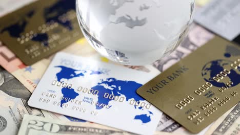 glass globe bank notes and credit bank cards