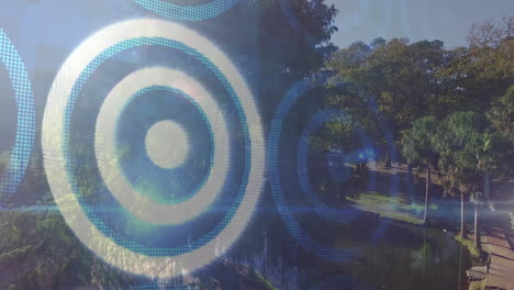 Circular target patterns animation over lush green park with trees and pathway