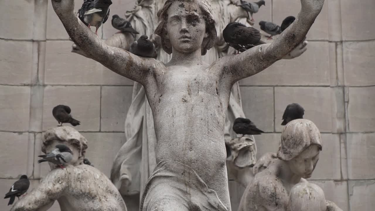 Close up of pigeons hanging out on a statue in New York City.