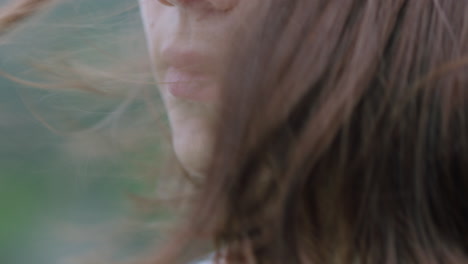 close up portrait of beautiful woman enjoying outdoors exploring spirituality contemplating journey with wind blowing hair