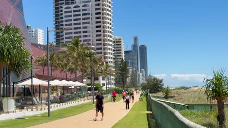 people walking along a sunny coastal path