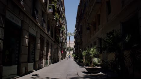 barcelona street scene with shadows, sunny day, pedestrians in distance, european architecture