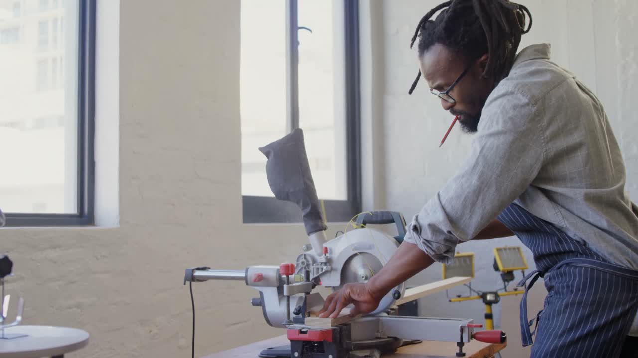 Carpenter cutting wooden plank with electric saw 4k