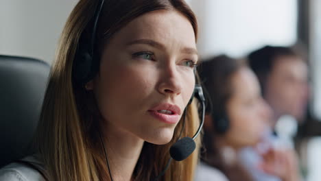 closeup friendly operator consulting client in headset. confident woman manager