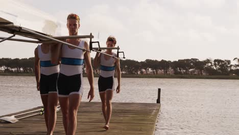 male rower team carrying the boat on their shoulders