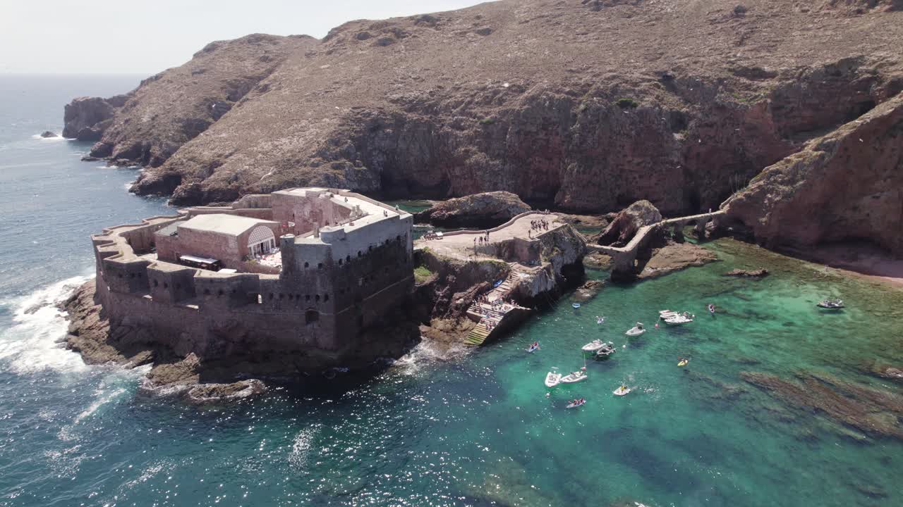 Seagulls flying over fort of S&atilde;o Jo&atilde;o Baptista aerial view orbiting shimmering coastal ocean fortress landmark, Portugal