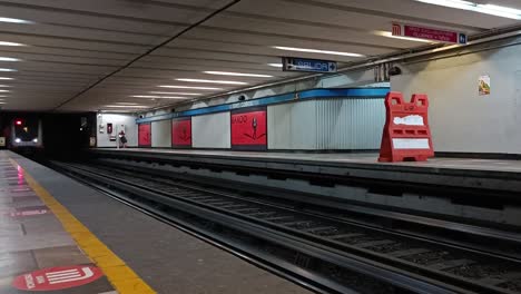 slow motion shot of an underground train approaching the underground platform